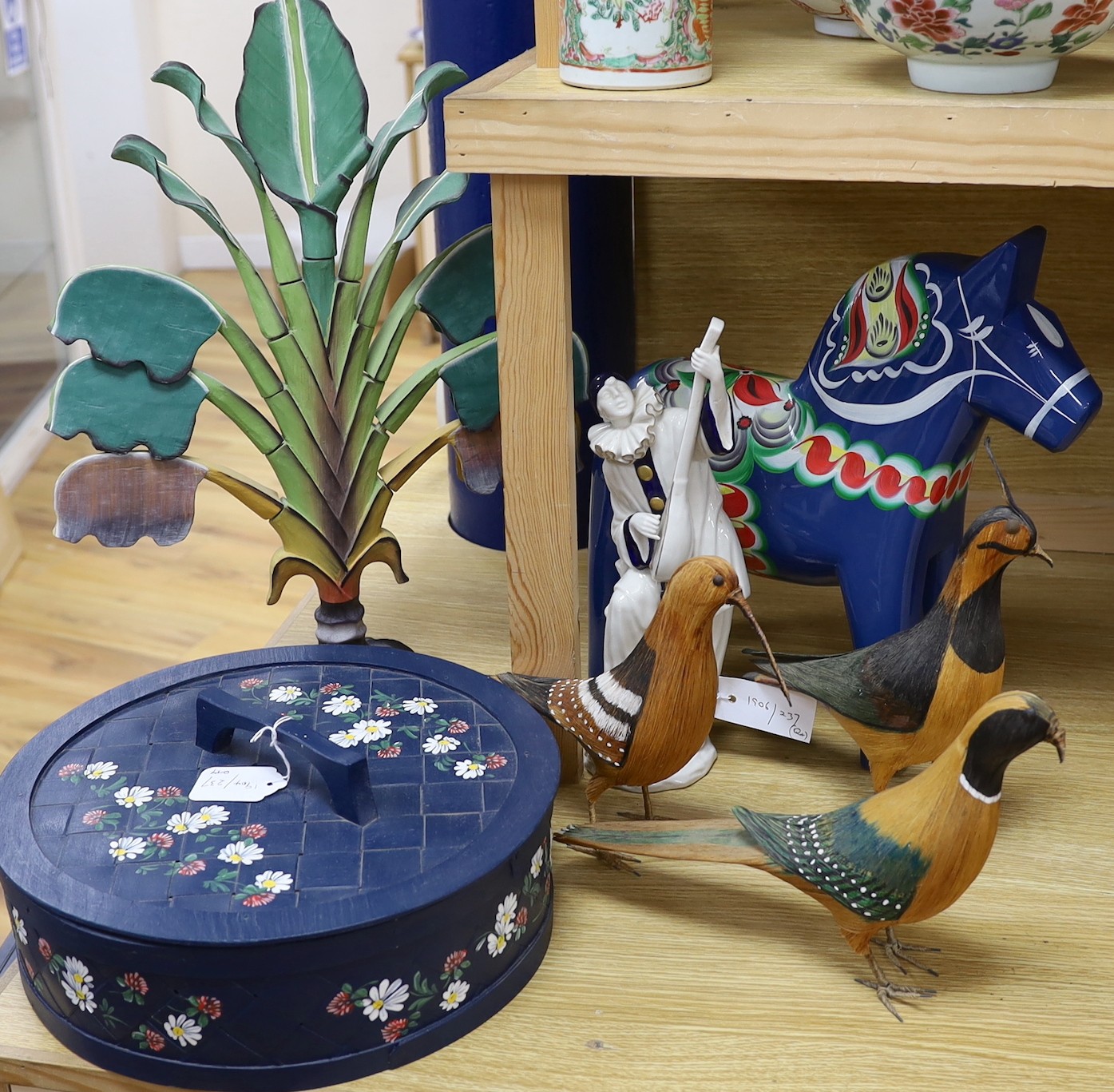 A Spanish porcelain model of Pierrot playing a mandolin, blue and gilt decoration, H29, a Swedish painted wood horse and decorative items